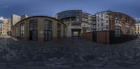 a circular shot of many buildings with windows and lights in front of them, taken in 3d