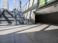 a person riding a skateboard down some stairs in a city under a large glass roof