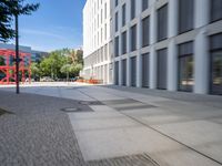 there is a view of a road and building with blurry background while on the left side is a view of the street is with a sidewalk