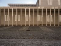 a view from the ground looking at the building with the tall columns down and one of the pillars missing