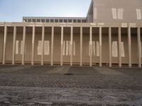 a view from the ground looking at the building with the tall columns down and one of the pillars missing