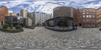 a series of circular panoramic photos of office buildings and a courtyard with a bench