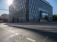 the sun shines over the windows and buildings near an empty street in a city