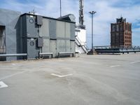 a parking lot with some sort of building in the background with a staircase leading up to it