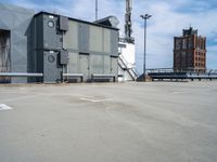 a parking lot with some sort of building in the background with a staircase leading up to it