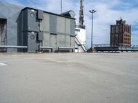 a parking lot with some sort of building in the background with a staircase leading up to it