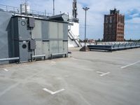 a parking lot with some sort of building in the background with a staircase leading up to it