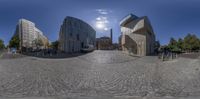 a 360 - lens shot of the road in front of the building on the left