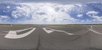 a mirror image shows an airport runway that has several arrows painted on the pavement and in the air