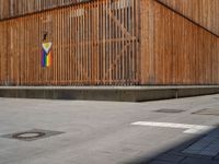 a group of people riding skateboards near wooden panels and stairss with artwork on them