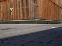 a group of people riding skateboards near wooden panels and stairss with artwork on them