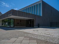 the entrance to an office building has several square glass doors on each side of it