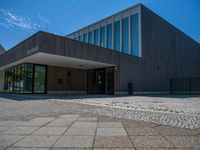 the entrance to an office building has several square glass doors on each side of it