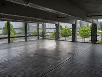 an empty parking garage with a view of the city in the background from inside the building