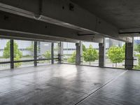 an empty parking garage with a view of the city in the background from inside the building