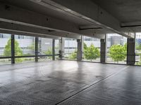 an empty parking garage with a view of the city in the background from inside the building