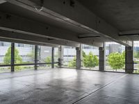 an empty parking garage with a view of the city in the background from inside the building