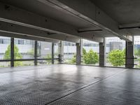 an empty parking garage with a view of the city in the background from inside the building