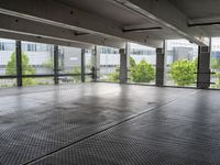 an empty parking garage with a view of the city in the background from inside the building