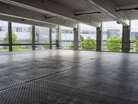 an empty parking garage with a view of the city in the background from inside the building