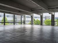 an empty parking garage with a view of the city in the background from inside the building