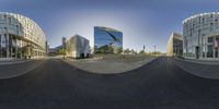 two fish eye glasses are looking into buildings with a sky background that looks like spherical