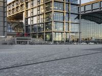 two buildings with lots of glass on top of them in the middle of a city