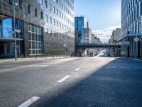 empty street with modern office buildings in background on sunny day in city skylines and business district