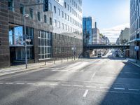 empty street with modern office buildings in background on sunny day in city skylines and business district