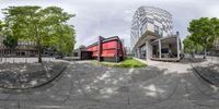 a 360 - image of the outside of the building and surrounding green vegetation and trees