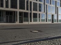 the street near the building with the sidewalk and a red fire hydrant on it