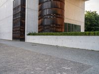 a person riding a skate board in the street on a brick pathway between two tall building