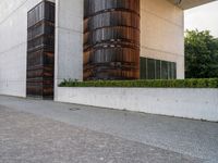 a person riding a skate board in the street on a brick pathway between two tall building