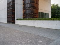 a person riding a skate board in the street on a brick pathway between two tall building