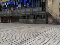 an image of the city sidewalk and outside of a building, taken from a moving vehicle