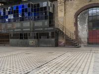 an image of the city sidewalk and outside of a building, taken from a moving vehicle