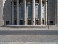 an entrance of a building with large columns and doors that spell out the word voltege