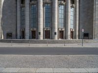 an entrance of a building with large columns and doors that spell out the word voltege