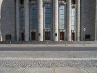 an entrance of a building with large columns and doors that spell out the word voltege