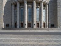 an entrance of a building with large columns and doors that spell out the word voltege