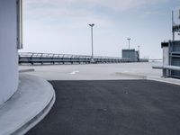 a boat is parked in an empty parking lot near an air port on the water
