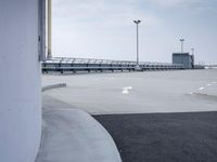 a boat is parked in an empty parking lot near an air port on the water