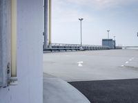 a boat is parked in an empty parking lot near an air port on the water