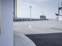 a boat is parked in an empty parking lot near an air port on the water