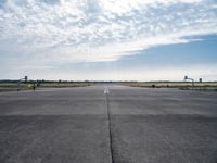 an airport runway with a traffic light, an air plane, and a basketball hoop