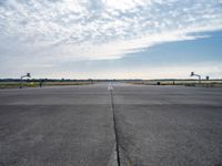 an airport runway with a traffic light, an air plane, and a basketball hoop