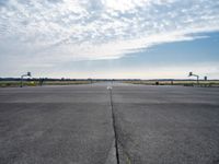 an airport runway with a traffic light, an air plane, and a basketball hoop