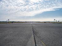 an airport runway with a traffic light, an air plane, and a basketball hoop