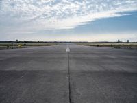 an airport runway with a traffic light, an air plane, and a basketball hoop