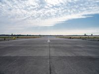 an airport runway with a traffic light, an air plane, and a basketball hoop